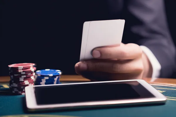 A young woman relaxing with her phone while dynamic casino elements float around her, illustrating the smooth mobile experience offered by the BIGPARII app.