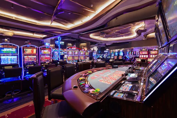 A glowing roulette wheel with cascading chips, symbolizing the engaging live and instant-win games available on BIGPARII.